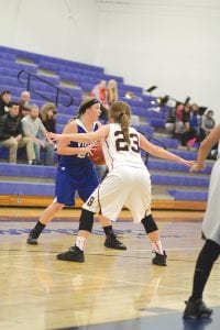 Above: Jami Sjogren looked to pass to an open Viking player as No. 23 closely guarded her in the game against Barnum. Left: Shauna Blake (3) had a great game against Barnum. Here she goes up to score 2 of her 9 points.