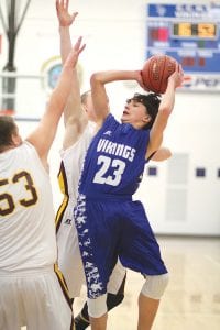 Marcus Logan’s first start came against Barnum, the second ranked 2A team in the state. Logan (23) got his shot off over two defenders' hands, but it caromed off the rim.