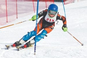 Above: There was great action at the USSA races at Lutsen Mountains. Will Lamb, who finished in 4th place, digs into a gate on Koo Koo. Left: Sela Backstrom skis her way to an impressive 6th place finish.