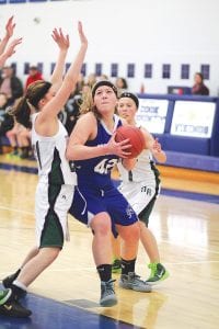 Left: Emily Jacobsen powered past two Northeast Range Nighthawk defenders to score two of her 9 points in the contest. Above: Maya McHugh had this shot blocked in the Vikings’ home game against McGregor, but it didn’t matter as the Vikings won 56-40 over the Mercs.