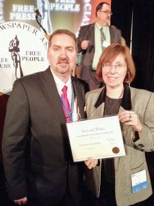 Minnesota Newspaper Association Board President Pete Mohs, of Echo Publishing, Pequot Lakes, presents the Lynn Smith Community Leadership Award to Cook County News-Herald Editor Rhonda Silence. The News-Herald was recognized for its work with community partners on the 2014 Move It! Awards.