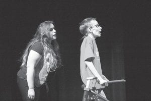 Cook County High School actors delighted the audience at the One Act Play presented on January 29. The play was We Loathe Our Customers and after seeing the play attendees know why. Above: A sales clerk (Erica Marxen) tries to help an obstinate bargain seeker (Sam Kern). Right: Harried mother (Hannah VanderHeiden) finds a piece of candy—no wait—a gerbil dropping while trying to pay for her purchase.