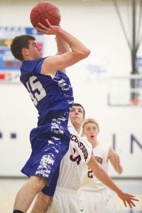 Rising high above his defenders, Andy Farley displays his sweet jump shot in a home game played recently against McGregor. Andy is a senior who plays the forward position for the Vikings.