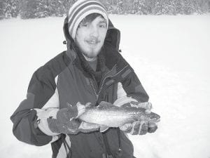 Tom Stacey holds one of three nice splake he caught from a lake located somewhere up the Gunflint Trail. Tom was fishing with expert North Shore fisherman Bruce Zimpel.