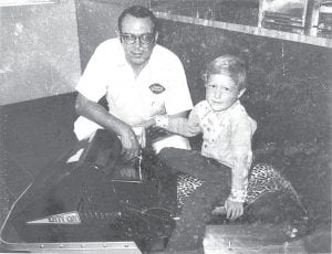 As the Grand Marais Dairy Queen reopens with a batch of new menu items, we thought it would be fun to share this photo from the Dairy Queen archives. Former Dairy Queen owner Stuart Jackson is pictured here with Terry Jackson. There must have been a Dairy Queen and Arctic Cat cross promotion. Terry is sitting on an Arctic Cat Kitty Cat snowmobile inside the ice cream shop.