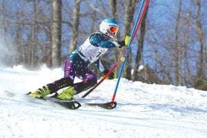 The three Viking Alpine skiers who went to the State meet at Giants Ridge represented Cook County well. Above: Eighth-grader Reilly Wahlers digs into a hairpin in her second run. She finished in 27th place against the top skiers in the state. And, Wahlers said, “It’s a blast to ski at State!”