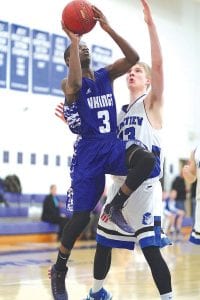 Left: Sam O’Phelan (3) made a strong move to the basket against Lakeview Christian, scoring 2 points. Above: Mike Burton (33), launched a long shot against Cromwell that didn’t quite go in.