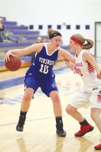 Lily Gruber-Schulz battles an aggressive Cromwell defender as she tries to make a move to the basket in a recent home game against the Cardinals.