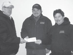 Cook County Curling Club President Bill Parish (left) accepts a check for $400 from Chris Smith and Rich Palmer, employees of Como Oil and Propane Company. The money was used toward the purchase of a nipper, equipment that helps prepare ice for play.