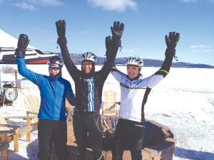 The top three finishers in the 20-mile race celebrating back at the bonfire at Grand Portage Lodge. (L-R) Josh Gillingham, 1st place finisher Keith Ailey, and Matt LaPointe. All three men are from Thunder Bay.