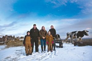 For generations the Berglund family has farmed on their land in the Maple Hill area of Grand Marais. They now operate Lake View Natural Dairy and are embroiled in a legal battle with the Minnesota Department of Agriculture over permitting of their dairy farm. Owners David and Heidi Berglund and their daughter Lyndsay Anderson (far right) operate the dairy. Also helping are David and Heidi’s younger children, the next generation of farmers, Spencer and Kendra. The heifer in the background? That’s Dora.