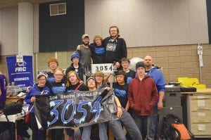 Above: The CCHS Robotics Team Ice Storm capped a great season off by competing in a weekend tournament at the DECC in Duluth. Team members are (L-R, front) Carrie Palmer, Shae Morawitz, Sara Carman, David Blackburn, Connor Franks, Isak Terrill, Noah Works. (L-R, middle) Sam Kern, Caleb Phillips, Bergen Soland, and Industrial Tech Instructor Peter Johnson. (L-R, back) Jacob Carr, Nate Carlson, and Brandon Bockovich. Left: Nate Carlson holds the controls as he directs the ‘bot in competition. Teammates to his left, Greg Howe and Sam Kern and Coach Peter Johnson on the right lend moral support.