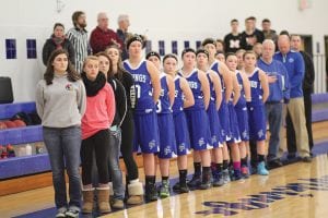 Standing at attention for the national anthem at a recent home game, the girls’ basketball team ended its regular season with back-to-back wins and headed into the playoffs playing its best basketball of the year.