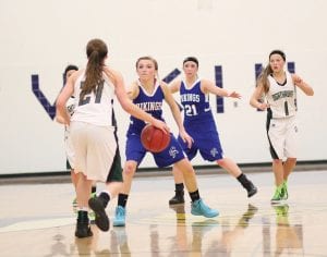 Above: Sophomore guard Sarah Toftey (with Jami Sjogren behind her) has been one of the Vikings’ top defenders all season and her tenaciousness on defense is one of the reasons the Vikings had a four-game winning streak at the end of the season. Above right: Lily Gruber-Schulz lofted a shot against the Lakeview Christian Lions. Gruber-Schulz scored 15 points in that game. Right: Surrounded by defenders, Emily Jacobsen (42) looks for an open player to pass to.