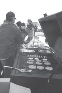 Above left: As always, there was a great lunch on the barbecue. Above right: Cook County Ridge Riders President Forrest Parson weighs one of the entries.