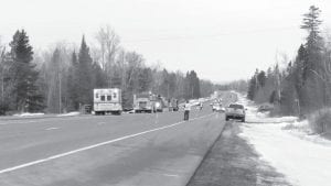 Emergency responders conducted traffic control on Highway 61 while firefighters battled a fire in a workshop at a home east of Tofte on March 13.