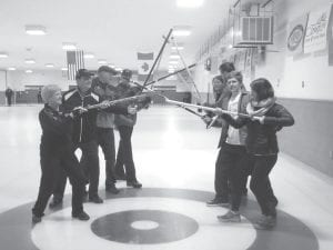 Family feud? Members of the two teams made up of Futterer family members and friends face off on the ice before the C event begins in the March 13 -15 Charles J. Futterer Memorial Open Bonspiel.