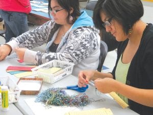 Shi and Czarina work on the book project designed to preserve memories and serve as personal inspiration.