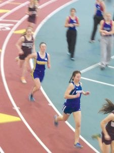 Left: Maya McHugh (front) led the Viking girls’ track team in the mile event with a 7th place finish in a strong field. Above: Getting ready to go into her spin, Alicia Smith gets set to throw the shot put at the Polar League indoor meet.