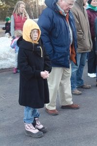 Left: At each stop, community members prayed for congregations in Grand Marais, as well as on the east and west ends of the county. Among them was Teagan Aldrich who offered her own heartfelt petition. Above: John Jacobsen takes a turn carrying the cross.