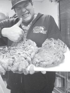 Cedar Denny, the cook’s helper, with some of the delicious Irish soda bread loaves he baked for the ENP's St. Patrick’s Day traditional meal.