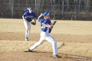 Far left: Andrew Miller is in full wind up as he pitches against Floodwood. Miller, an eighth-grader, gave up 3 hits but struck out two as he came in and pitched the 7th inning for the Vikings. Above: Travis Bradley applies a tag to a Floodwood runner. Left: Center fielder Owen Anderson checks a runner at second before throwing home.