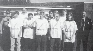 State Trooper Leah Erickson and Police Chief Tom Billings awarded T-shirts to students at Cook County High School who wore their seat belts on April 16, 1996. From left in front are Gideon Silence, Ben Silence, Janelle Larsen, Alison Stone and Meredith Church-Davison. In rear are Trooper Erickson, High School Principal Mark Sandbo, Tyler Norman, Roger Kloster, Chris Morris and Chief Billings.