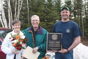 Maple Hill Fire Department volunteer Richard “Dick” Parker was honored by his colleagues for his service to the fire department at a celebration on Tuesday, April 28. Fire Chief Kent Anderson presents the stunning bronze plaque that will hang at the fire hall. (L-R) Phyllis Parker, Dick Parker, Fire Chief Kent Anderson.