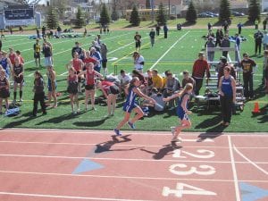 Above: Sarah Toftey makes a perfect exchange with the baton to Robin Henrikson. Far left: Will Surbaugh runs to a 4th place finish in the 2-mile with a time of 12:39. Left: Showing good form, Aurora Schelmeske races to a 5th place in the 800 meters. The athletes competed at the Esko Showcase Showdown track meet on May 2.