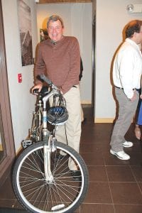 Above: The successful bidder on this mountain ready bike was Paul Renneisen. Right: Birch Grove Community School Board Members Diane Blanchette and Sarah Somnis had fun greeting people to the gala.