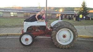 Top: Cook County High School Prom 2015 had a country “Footloose” theme. Attendees traveled to prom via some unconventional modes of transportation. North Shore girls like Raynee Wolke like tractors!