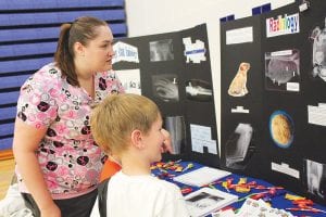 The School District 166 Career Fair had many opportunities for students to consider different careers. North Shore Hospital had personnel on hand from laboratory, dietary, emergency services, and radiology. This young man checks out some X-rays.