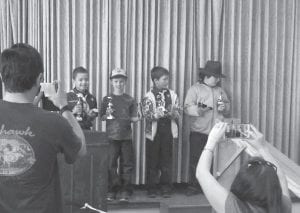 Above: Cook County Cub Scouts held their annual Pinewood Derby in the fellowship hall at St. John’s Catholic Church on April 18. The Scouts with the winning cars were (L-R) Aiden Robinson, Ruben Youngdahl, Ethan Tate, and Daniel Bockovich. Right: After months of designing, carving, painting and testing their gravity-driven cars, Scouts were ready for the big racetrack.