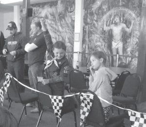 Above: Wyatt Hadley cheers as his racecar crosses the finish line.