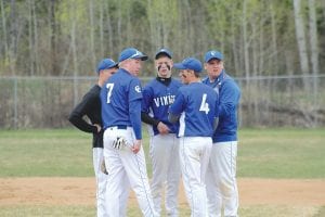 A meeting of the minds: The infield came to the mound to discuss strategy in a recent home game. (L-R) Rory Bakke, Travis Bradley (7), Leo Johnson (center), Frankie Miller (4) and Jamie Wick.