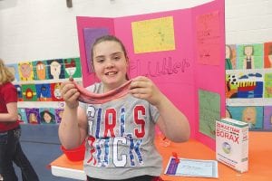 The Sawtooth Mountain Elementary School Project Fair on May 14 had some clever projects. Aurielle Housey shows off the colorful, stretchy substance she created. It’s Flubber!