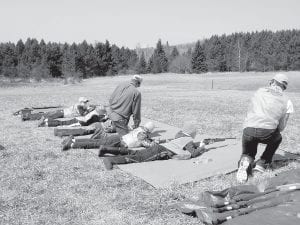 Twenty Cook County students attended Minnesota Department of Natural Resources (DNR) firearms safety training in April. Students are pictured here on field day practicing firing .22 caliber rifles at targets.