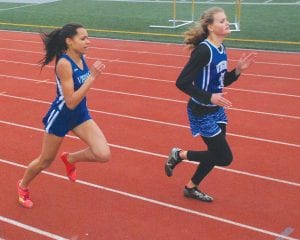 Above: Molly Thomas, a CCHS sophomore, finished 5th place in the 400 meters at the section meet in a career best 62.78 time. This is believed to be the third fastest quarter mile ever run by a Viking girl. Left: Matea Acero, a CCHS junior, ran a lifetime best 12:31.5 for 3200 meters (2 miles) at the Section 7A track finals to take 8th place.