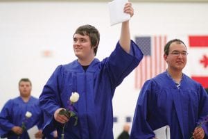 Cook County High School Class of 2015 graduates were all smiles as they left commencement exercises on Saturday, May 30. As Zack Anderson (left) and Rusty Day exited, Zack gave a celebratory wave—diploma in hand! See more of the CCHS graduation ceremony on page B5.