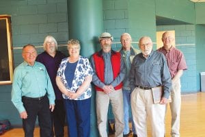 Above: Current and new board members expressed appreciation to outgoing board member Howard Abrahamson. (L-R) Keck Melby, newlyelected board member Stan Tull, Sharon Bloomquist, Mike Littfin, Thomas Spence, former board member Howard Abrahamson, Les Edinger. Left: Members enjoyed trying to generate electricity through bike power.