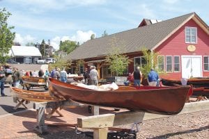 In between rain showers, visitors to the North House Folk School campus in Grand Marais enjoyed looking at the boats on display during the Wooden Boat Show weekend, June 19-21. The rain did make the gleaming woodwork on the boats glisten. Fortunately there are tents for the amazing craft demonstrators and lots of indoor activities, such as the interesting speaker series and the Boats-to-Tools Auction.