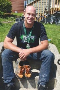 Above: Chris Skildum traded his running shorts for painting pants a couple of days after Grandma’s Marathon. Skildum finished the 26 mile 385 yard race in 4 hours 34 minutes and 33 seconds.