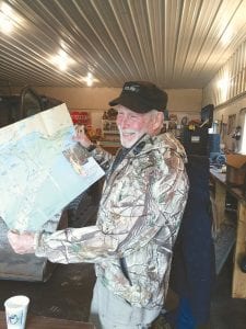 The Cook County ATV Club Kick Off Party on June 20 did not include a long ride because of the rain. The ATV Club appreciated use of the Cook County RidgeRiders Snowmobile Club groomer building. Above: John McClure checks out a map to plan future rides.