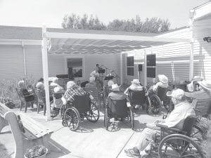 The residents at North Shore Care Center had excellent weather for the outdoor concert this past week. The Flute Reed Ramblers are John and Martine Redshaw on guitar with Kristen Carlsgaard on the fiddle.