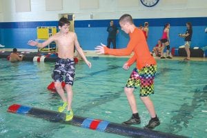 On the left, Dominic Wilson worked the log hard against a competitor in a recent meet. Good rollers can start and stop a log in an instant, which can cause their competitor to fall. The first roller to cause his competitor to fall three times wins the match.