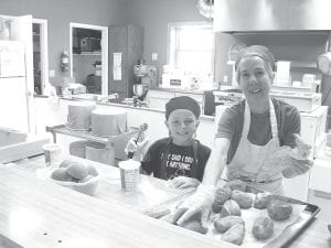 Eight-year-old Rayce proved to be a big help at the Senior Center on June 10, helping Senior Center Cook Ann prepare Meals on Wheels for delivery. Rayce is following in his mother, Jes Rodne’s footsteps. Jes, the new Programs and Service Coordinator is the granddaughter of the first Senior Center Director Marie Gilbertson. She spent a lot of time at the senior center as a child.