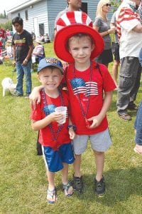 Enjoying Independence Day! Brothers Andrew (left) and Alex Bennis, of Oakdale, Minnesota, had a great time during the Tofte 4th of July celebration. Asked if the minnow in his cup would win the minnow races, Andrew gave a confident “yes.” He was correct, he went on to win!