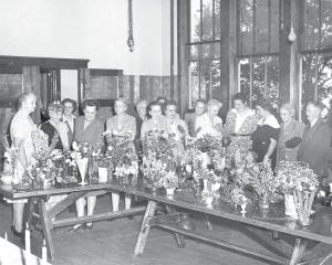 Above: Enjoying beautiful bouquets has been a West End Garden Club tradition for 80 years. Inset: Debby Rebischke and Mary Jo Roche, members of the West End Garden Club, pause to reflect on the garden club’s 80-year history.