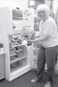 Elizabeth Peterson checks out the Community Supported Agriculture (CSA) offerings at Birch Grove.