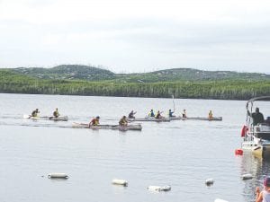 The normally placid Gunflint Lodge shoreline was bustling with action on July 15 as the Gunflint Canoe Races got under way. Top: Liz Smalley and Dan Ahrendt, representing Tuscarora Lodge celebrate at the finish of their race. Middle: The competition was fierce on the shoreline too, with minnow racing action. Bottom: The Gunflint Volunteer Fire Department, which benefits from the event, showed its gratitude by helping cool off the crowd.